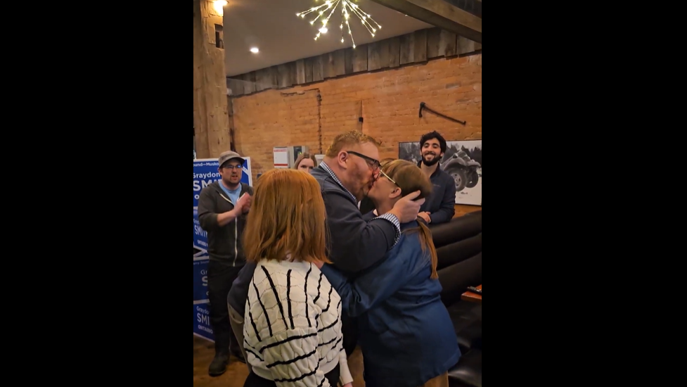 Graydon-and-wife-kiss.png